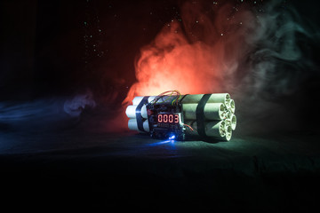 Image of a time bomb against dark background. Timer counting down to detonation illuminated in a shaft light shining through the darkness