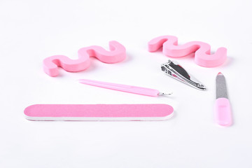 Equipment for pedicure, white background. Pink color tools for pedicure making, isolated on white background. Still life of pedicure instruments.