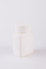 White blank plastic bottle for medicine. Empty pills bottle isolated on white background.