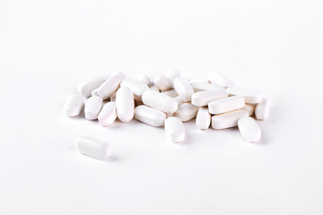 Fototapeta na wymiar White medical pills on white background. Medical tablets on white background. Medicine and health care concept.