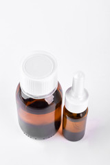 Cough syrup and nasal spray, top view. Medicine bottles isolated on white background. Nasal spray container.