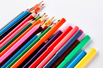 Rainbow collection of pencils for drawing. Big collection of pensils and markers of different colors, white background.