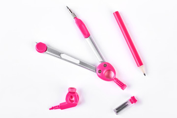 Pink compasses and pencil for drafting. Professional equipment for project drafting. Instruments for drawing at school.