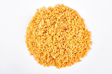 Pile of letter shaped stelle pasta. Heap of italian little stelline pasta on white background. Italian traditional food.