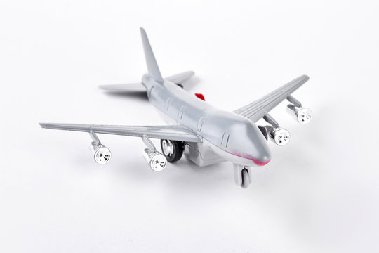 Grey toy air plane on white background. Plastic toy jet plane isolated on white background. Photo of toy air transport.