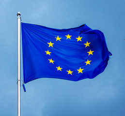 The flag of the European Union , against the background of the sunny sky.