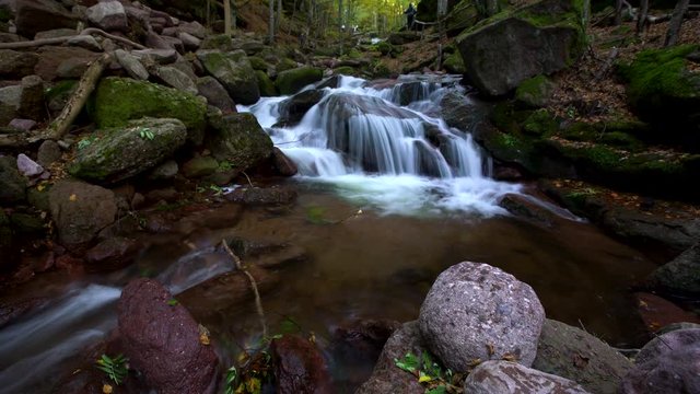 Autumn forest waterfall river with rocks in the mountain landscape. Kopren, Bulgaria, Europe.