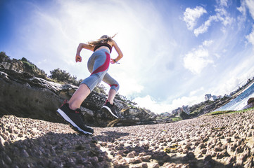 Sporty runner woman run on the coastline