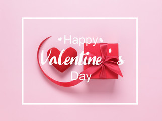 Table top view image of decoration valentine's day background concept.Flat lay of red heart shape and gift box with text design backdrop on modern rustic pink paper at office desk.pastel tone.