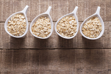 oat flakes in white bowl on wooden table