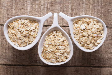 oat flakes in white bowl on wooden table