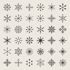 Set of hand drawn snowflakes. Delicate snow icon silhouettes. Vector illustration with editable strokes. Isolated on white background. Winter design elements for christmas and seasonal greetings.