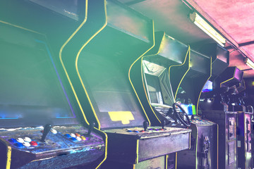 Old used classic forgotten Vintage Arcade in room and none of players playing video games in the frame. Game machine cabinet with pixel screen and colorful controllers . Games for kids  from childhood - obrazy, fototapety, plakaty