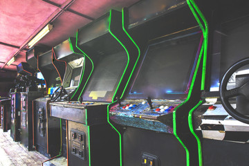 Old used classic forgotten Vintage Arcade in room and none of players playing video games in the...