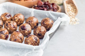 Healthy homemade energy balls with cranberries, nuts, dates and rolled oats, horizontal, copy space