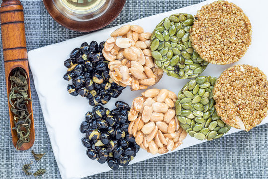 Korean traditional sweet snacks with peanuts, pumpkin seeds, black soybeans and chinese buckwheat. Healthy energy snacks. Top view, horizontal