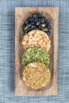 Korean traditional sweet snacks with peanuts, pumpkin seeds, black soybeans and chinese buckwheat. Healthy energy snacks. Top view, vertical