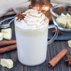 Hot white chocolate, decorated with whipped cream and cinnamon, square format