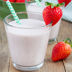 Healthy smoothie with strawberry, banana and yogurt in glass, square format