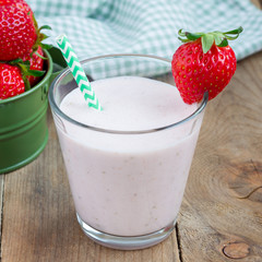 Healthy smoothie with strawberry, banana and yogurt in glass, square