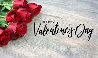 Happy Valentine's Day Calligraphy with Rose Bouquet Over Rustic Wood Background
