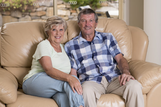 Senior Beautiful Middle Age Couple Around 70 Years Old Smiling Happy Together At Home Living Room Sofa Couch Looking Sweet In Lifetime Love