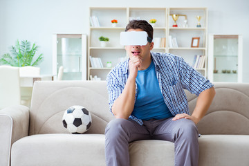 Man wearing virtual reality VR glasses watching soccer football