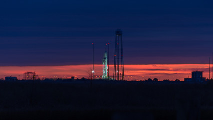 Sunrise over the Orbital ATK Antares rocket at NASA's Wallops Flight Facility - Powered by Adobe