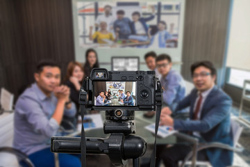 Professional digital Mirrorless camera with microphone recording video blog of Group of asian Business team having video conference,Camera for photographer or Video and Live Streaming concept