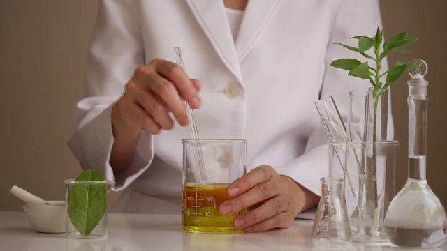the scientist,dermatologist testing the organic natural cosmetic product in the laboratory.research and development beauty skincare concept.blank package,bottle,container .cream,serum.