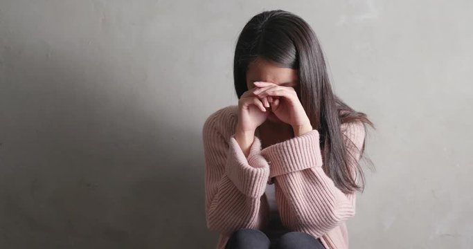 Depression woman crying over gray background