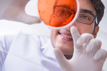 Chemist working in the laboratory with hazardous chemicals 