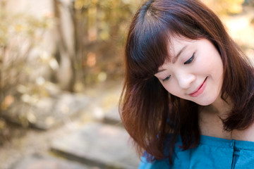 Close up of young pretty Asian woman in the garden.