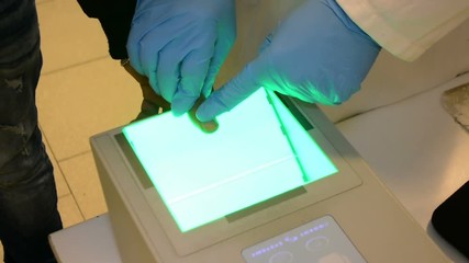 Fingerprints, taking fingerprints on scanner for identification - Powered by Adobe