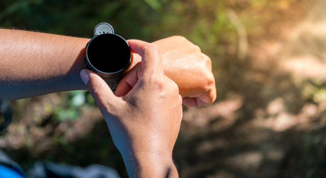 Woman use of smart watch for running in the park