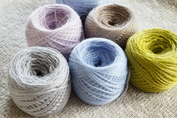 Clusters of yarn in colors of Scandinavian style on knitted cloth. Close-up. Electoral focus.