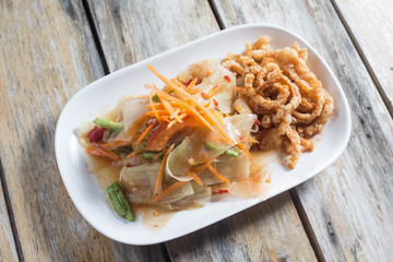 papaya salad with hot and spicy taste with vegetables for local food background