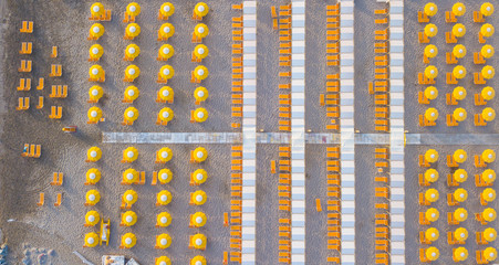 Top down drone aerial view of the umbrellas and gazebos on Italian sandy beaches. Riccione, Italy. Adriatic coast. Emilia Romagna region
