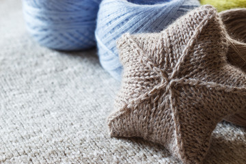 A yarn for hand knitting and a knitted item. Copy space. Selective focus.