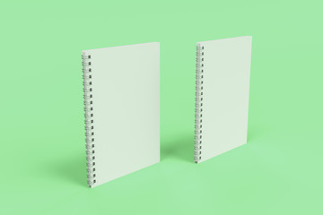 Two notebooks with spiral bound on green background