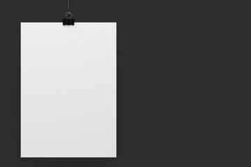Blank white poster with binder clip mockup on black background