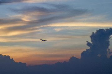 Plane with the evening sky and clouds