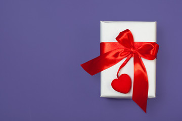 White gift box with red heart on ultra violet background. St. valentine's greeting concept. top view, flat lay