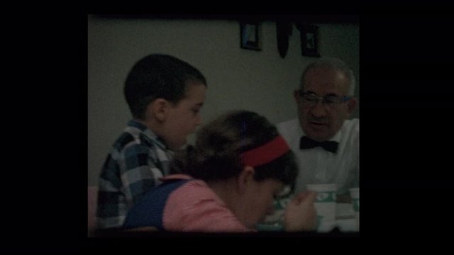 1964 Grandfather and grandkids at dinner table