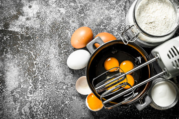 Baking background. Blend eggs with a mixer to make a dough.