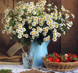 Daisies and basket of strawberries, rustic still life.