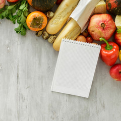 Top view set raw food notebook wooden background. Healthy food