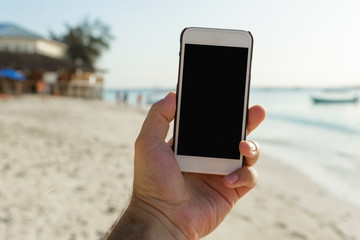 Male hand holding smartphone with blank screen close up