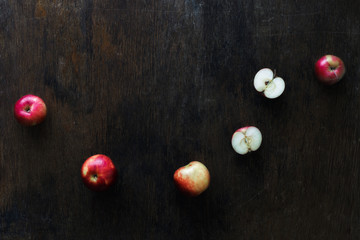 Slices red apple dark wooden table copy space, top view