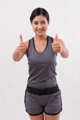 confident happy smiling fitness woman giving thumb up